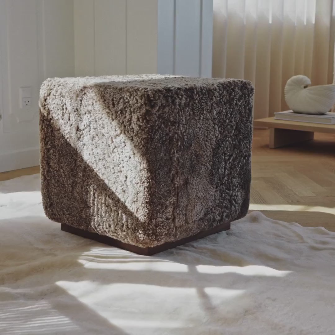 Cube footstool in brown sheepskin in the sunlight