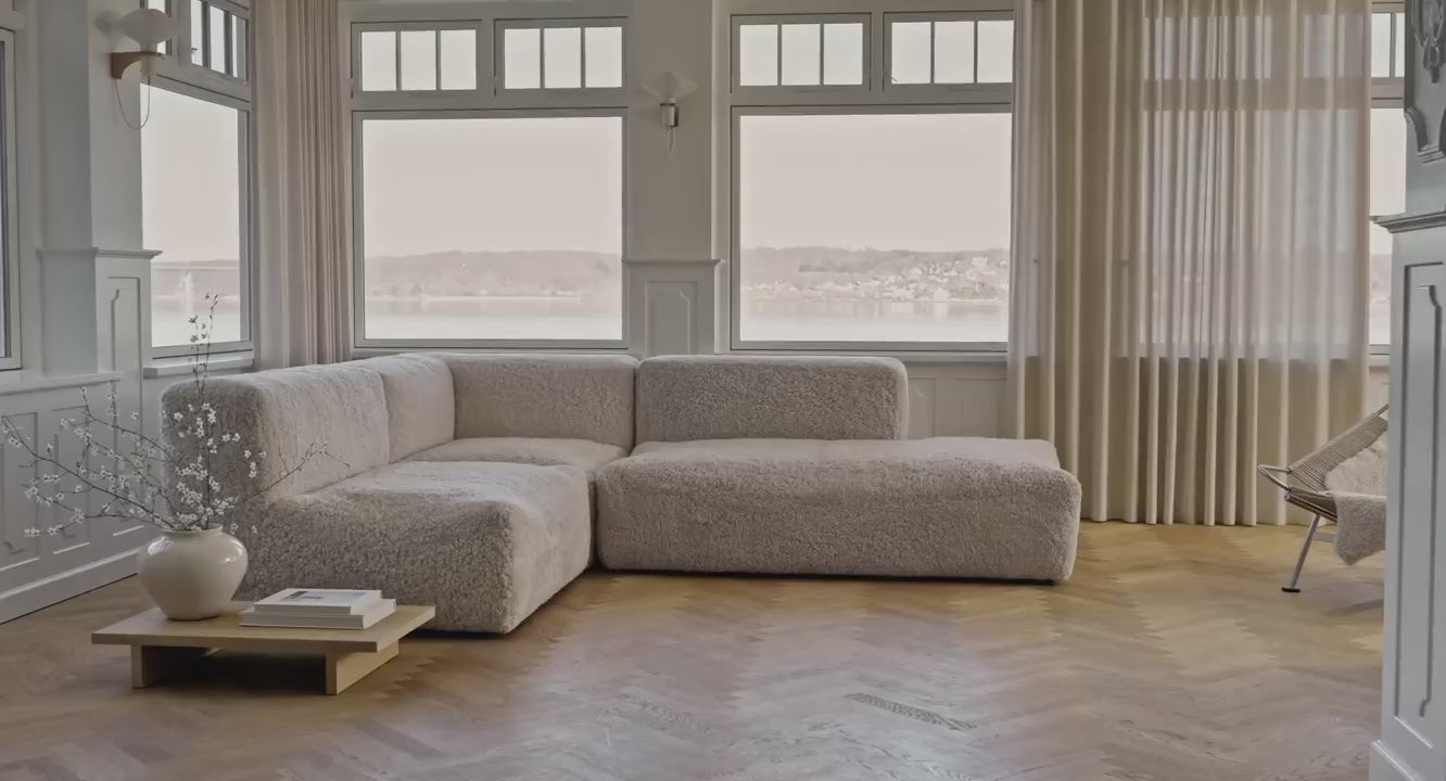Sofa in cream short-wool sheepskin in a bright living room