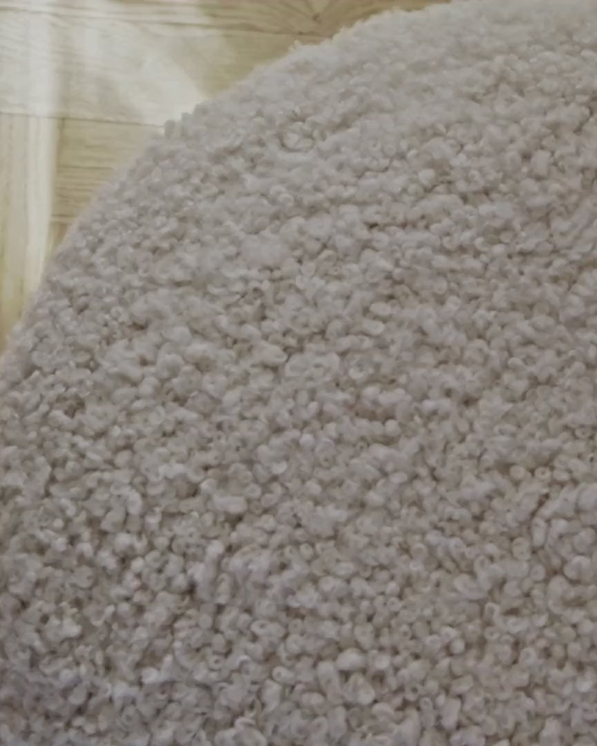 Woman relaxing in an armchair covered in long-wool sheepskin