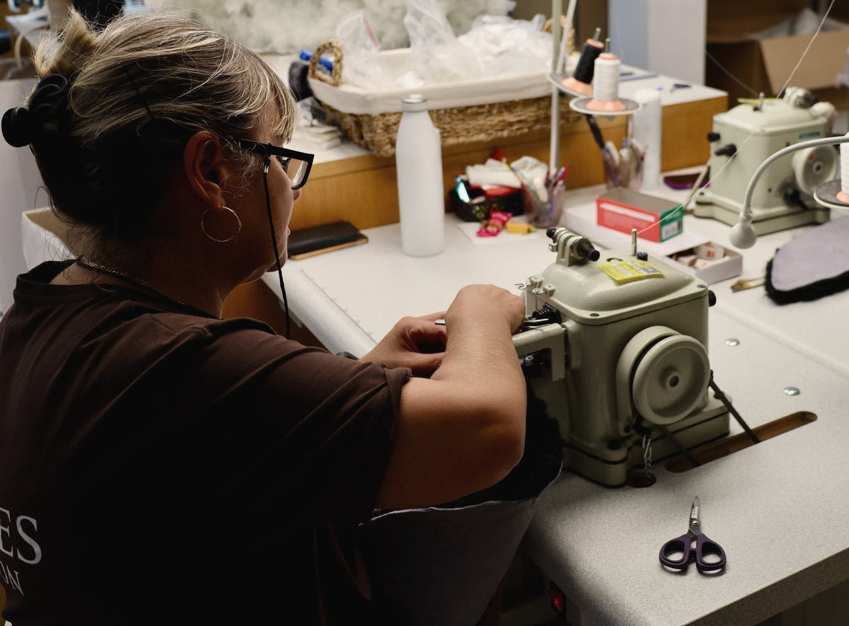 A seamstress working at a fur sewing machine