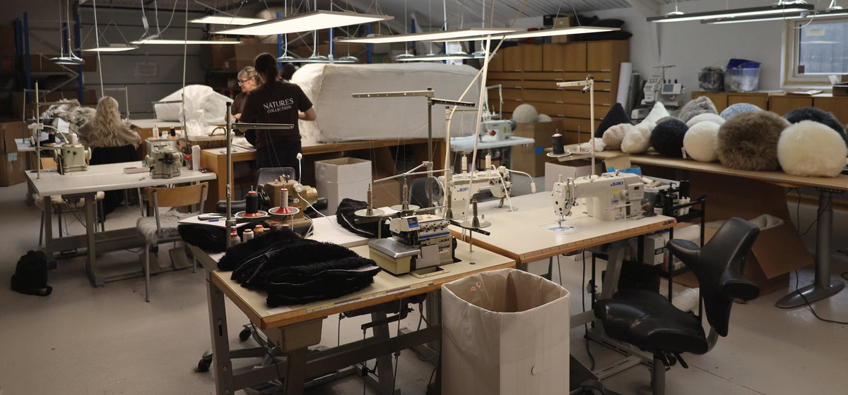 Our sewing studio in Denmark, with sewing machines and stacks of sheepskins